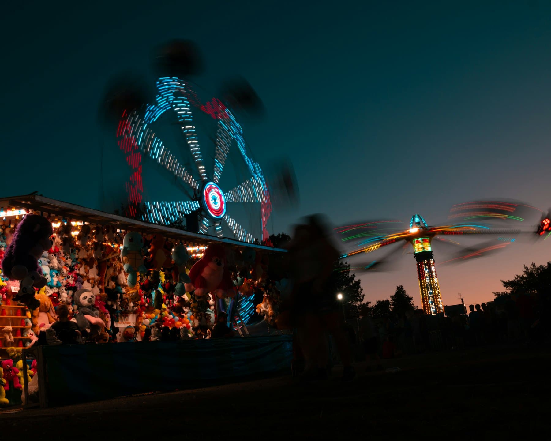 Carnival rides lit up at night at a county fair